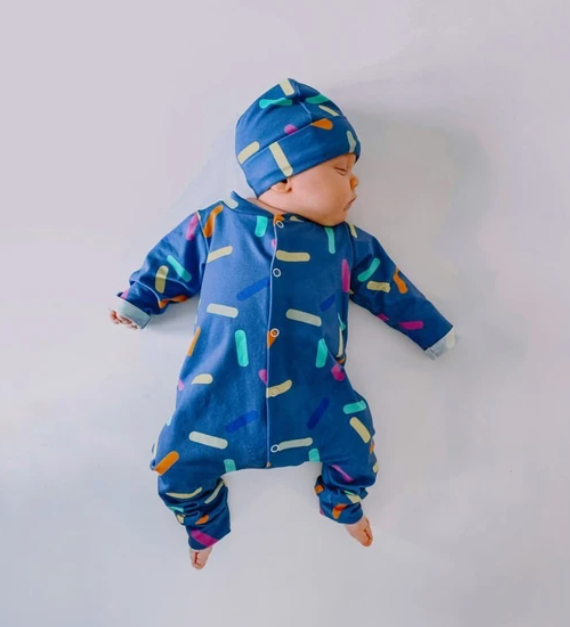 Confetti Romper and Hat Set by Little Loves Cornwall, slate blue with multicolour confetti sprinkle print, worn by baby