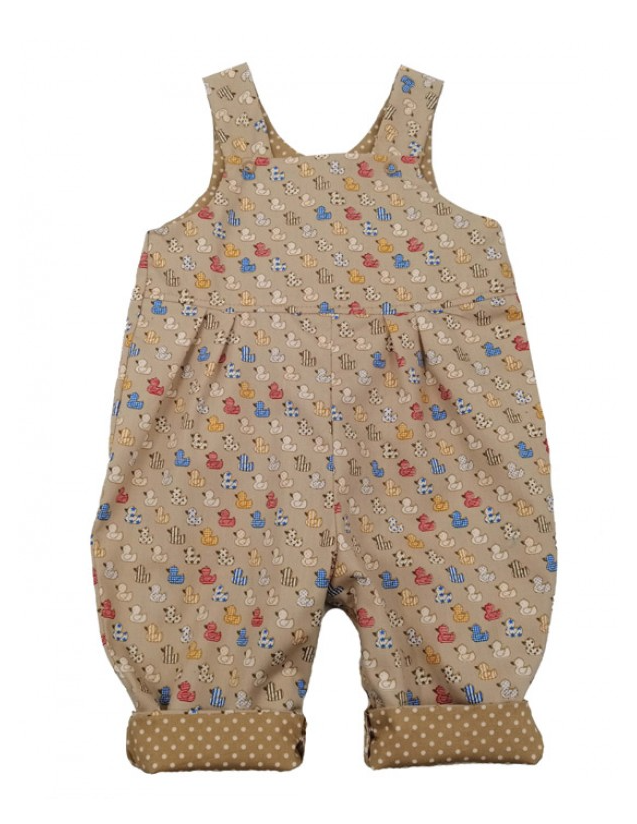 Ducks Reversible Dungarees by Seesaw, polka dot side shown, warm sandy beige with white dots, cuffed hems revealing duck print reverse