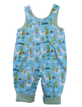 Llama Reversible Dungarees by Seesaw, llama print side shown, sky blue with white llamas, cacti and colourful saddle blankets, cuffed hems