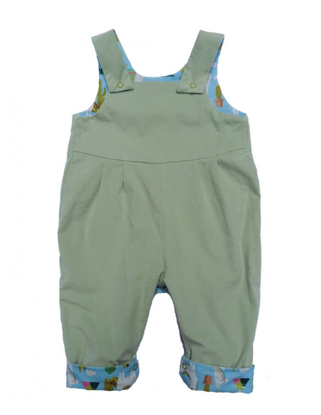 Llama Reversible Dungarees by Seesaw, solid sage green side shown, llama print visible on cuffed hems and straps