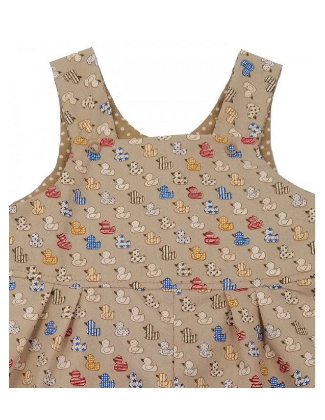 Ducks Reversible Dungarees by Seesaw, duck print side full view, pleated bib and wide straps, cuffs showing polka dot reverse