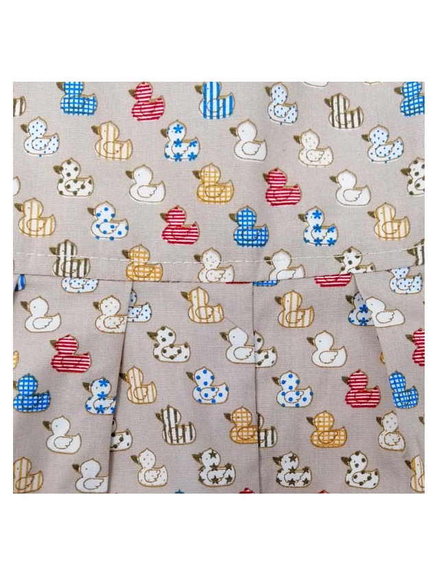 Close-up of Ducks print fabric by Seesaw, illustrated rubber ducks in various patterns on warm sandy beige background