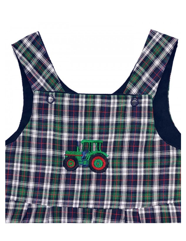 Connor Reversible Dungarees by Seesaw, close-up of tartan bib with embroidered green tractor with red wheels and snap buttons