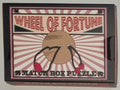 Wheel of Fortune Matchbox Puzzle by Professor Puzzle — circular metal wire ring disentanglement brainteaser in matchbox-style box, ages 8+